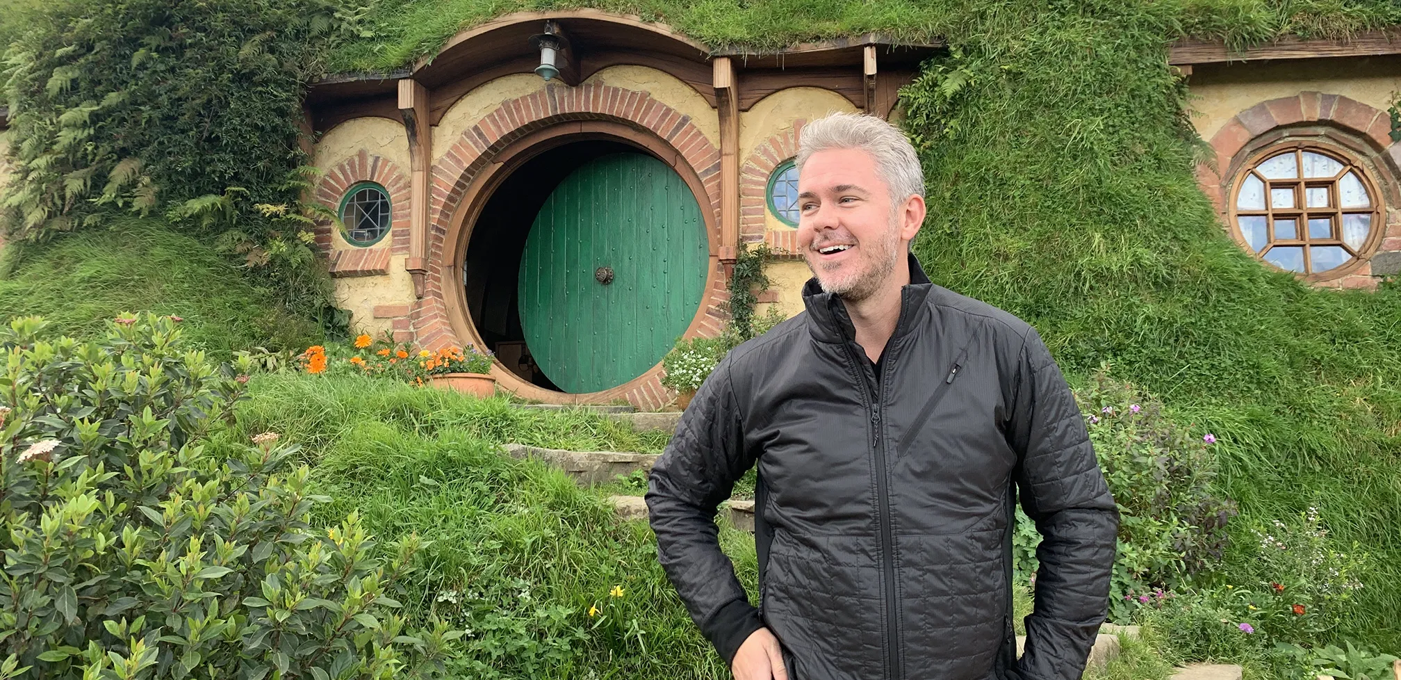 Bret McGowen laughing in front of some Hobbit doors