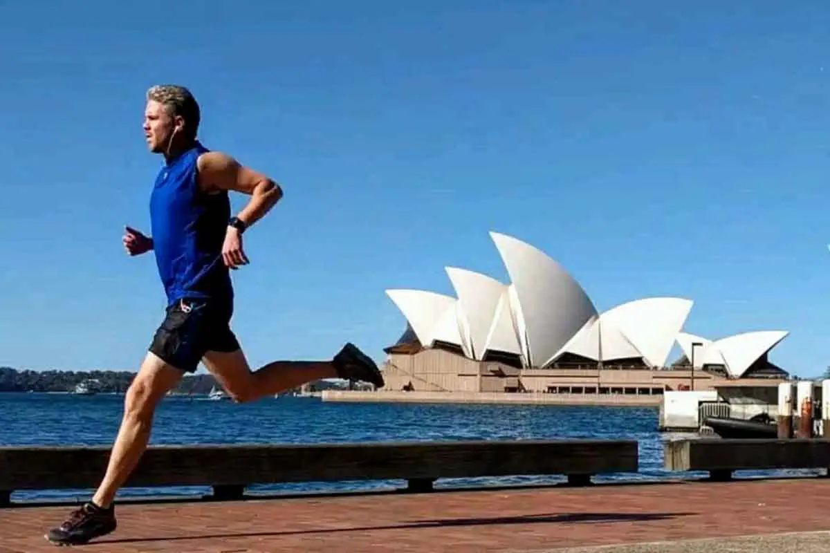 A photo of Bret McGowen running in front of the Sydney Opera House